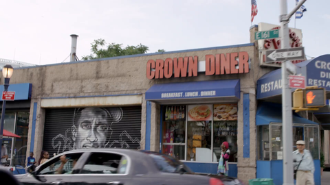 161 street in the South Bronx driving past famous Yankee sports figures murals spray painted on storefront gates - slow motion 4K NYC