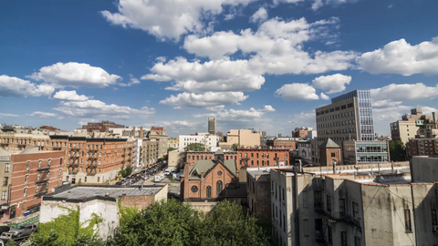 timelapse of Harlem during day - 4K from rooftop overlooking Uptown Manhattan neighborhood church in New York City