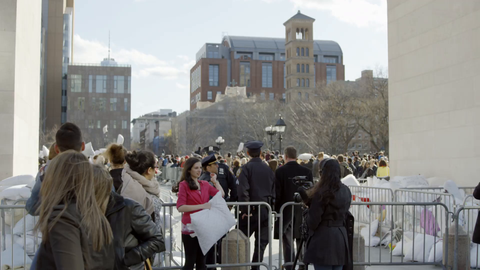 police and NYU students in Washington Square Park from underneath arch on pillow fight day - 4K slow motion in New York City