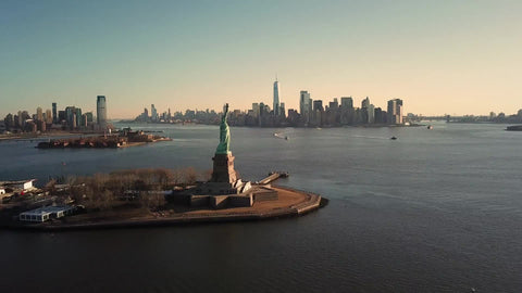 Statue of Liberty forward aerial toward Manhattan New York City skyline 4K and 1080 HD NYC