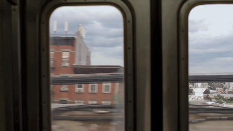 interior window view of Brooklyn from elevated subway train in NYC