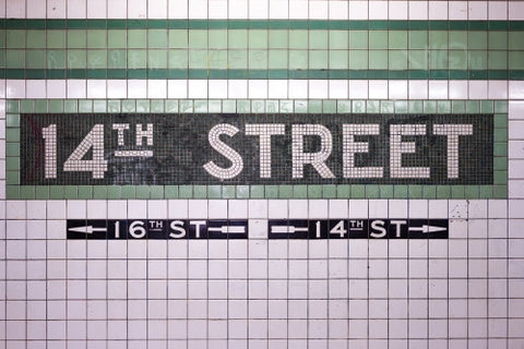 14th street sign on tiled wall in subway station in NYC
