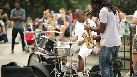 musicians playing saxophone and drums in Washington Square Park - saxophonist and drummer jamming in NYC