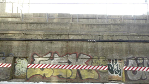 gritty graffiti art on subway wall outside - view from moving train in 1080 HD NYC