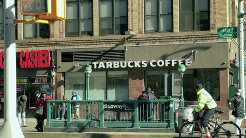 people on bustling intersection of 125th street and Lenox Malcolm X Blvd Harlem New York City NYC