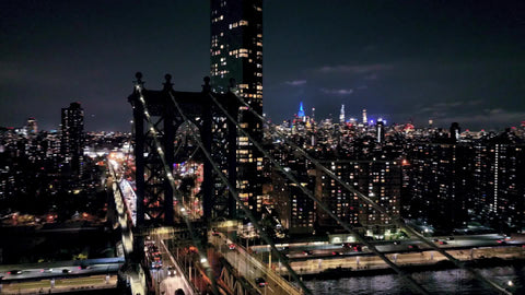 aerial circling close Manhattan Bridge night New York City