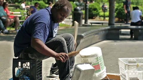 talented percussionist drumming pots pans and buckets - banging drum patterns on metal in Washington Square Park