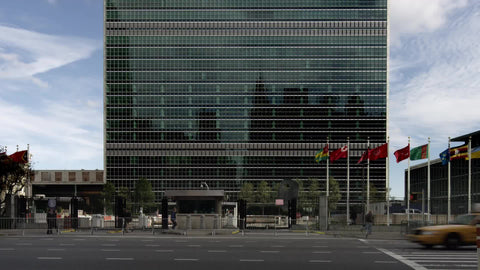 taxicab driving past United Nations building in traffic on 1st Ave in Manhattan NYC