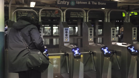 woman entering subway turnstile in Manhattan train station heading Uptown and The Bronx New York City NYC