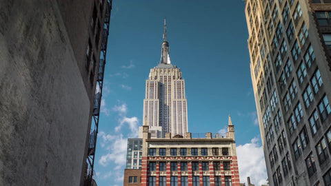time-lapse zooming in on Empire State Building during day - close-up view from alley between two buildings