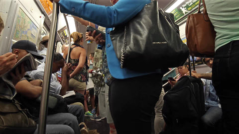 crowded subway train interior from passenger pov in summer