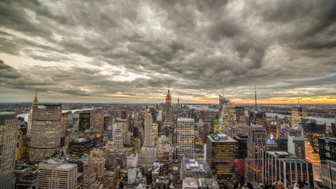 Empire State Building and Manhattan cityscape with beautiful cloud pattern overhead at sunset in early evening