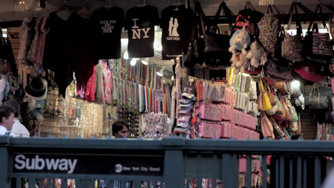 Canal Street subway station entrance outside in Chinatown with shops selling trinkets and what not
