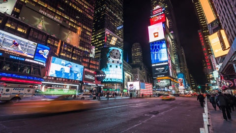 Times Square at night with bright lights, ads, billboards and traffic - 4K in NYC