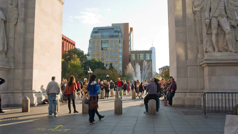 water fountain view through famous arch on beautiful summer day in Washington Square Park