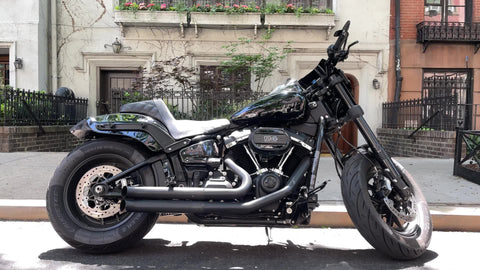 motorcycle parked on street in front of residential townhouse in New York City NYC