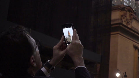 tourist man taking smartphone picture of Chrysler Building in Manhattan