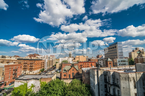 Harlem neighborhood with church from rooftop on bright beautiful sunny summer day in Uptown Manhattan, blue sky and clouds