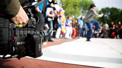 RED cinema camera filming outdoor performance in park in New York City
