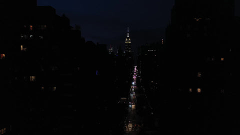 pulling back on 5th Ave from Empire State Building over Washington Square Park arch Manhattan New York City NYC night