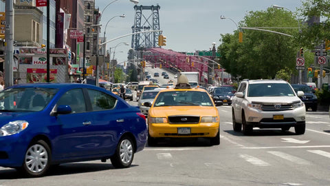 cars in traffic exiting Williamsburg Bridge in Manhattan's Lower East Side on summer day