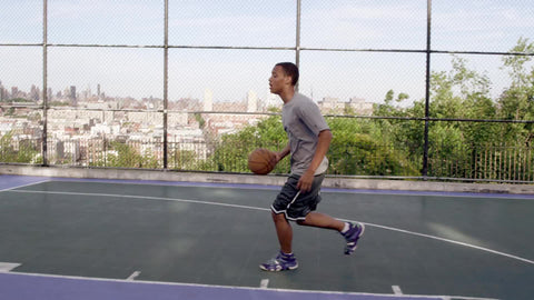 kid scoring beautiful layup practicing basketball on New Jersey courts in summertime