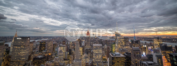 Manhattan at sunset from high view with Empire State Building and city lights in NYC
