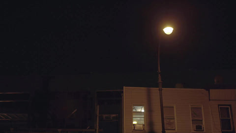 subway train on elevated track at night in Brooklyn in New York City