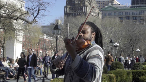 man playing violin in Washington Square Park on fall day in NYC - no audio