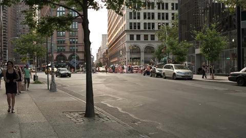 cars and taxi cabs driving from Cooper Square toward East Village in Manhattan in summer NYC