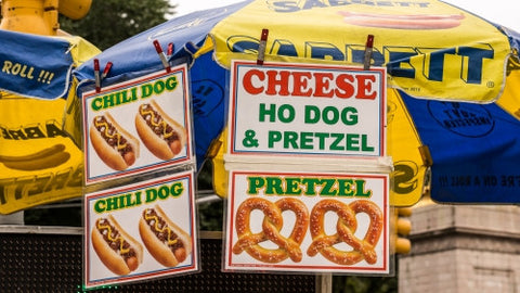 hot dog vendor umbrella - pretzels, cheese and chili dogs on sunny day