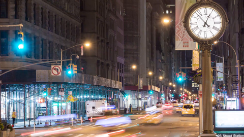 traffic lights changing with fast moving cars in evening, timelapse of 5th Avenue clock in 4K and 1080 HD in NYC