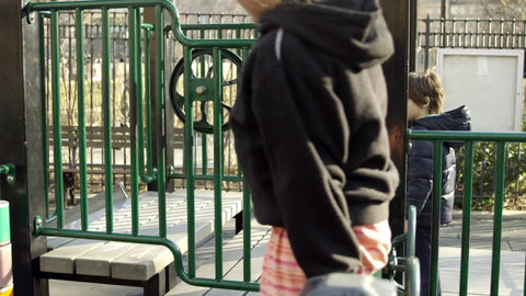 boy and girl playing on jungle gym structure in Washington Square Park playground on sunny day in winter in 4K and 1080 HD in NYC