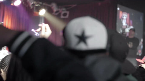 crowd at hip hop show in NYC - people with hands in the air in slow motion