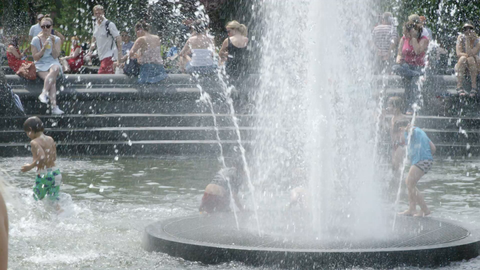 children playing and splashing in Washington Square Park fountain in summer - slow motion 4K NYC