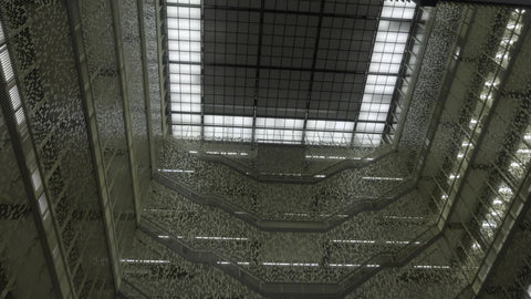 interior famous Bobst Library at NYU tall ceiling tilting down to checkered floor lobby