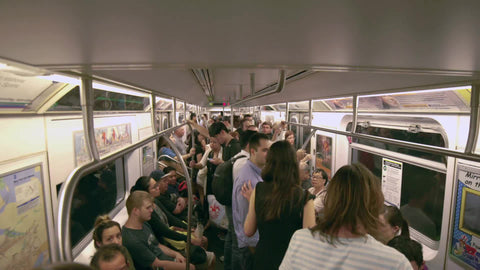 moving subway train interior - people on crowded carriage in summer - New York City