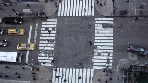 people walking on street from high up - aerial view of crosswalk and intersection in Midtown Manhattan 4K and 1080 HD in NYC