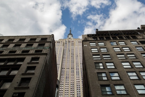 Empire State Building seen through two buildings from low view looking up