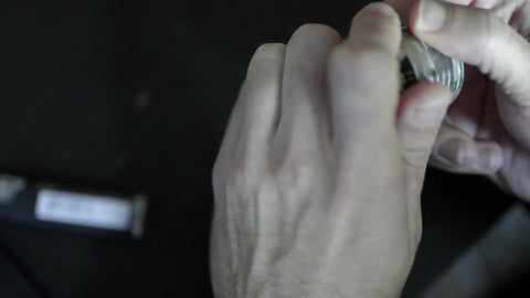 closeup of hands grinding weed - marijuana grinder