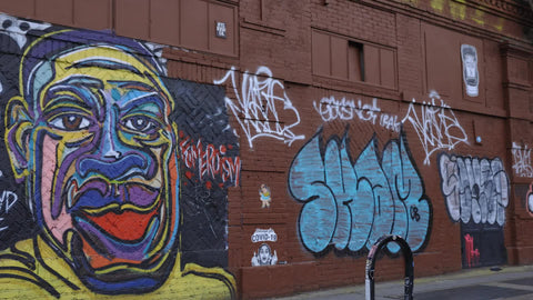 driving past George Floyd mural on Christmas with people in santa hats on Lower East Side Manhattan New York City NYC