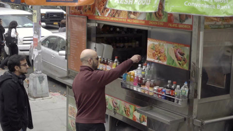 man paying for food at Halal truck