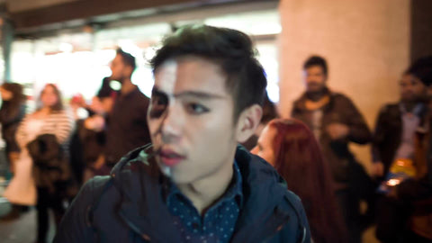 close-up of Asian American man with scary makeup paint on face in Halloween parade