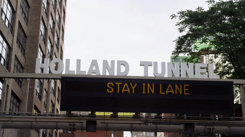 Holland Tunnel and stay in lane sign overhead