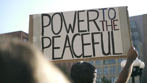 power to the peaceful sign at rally in New York City