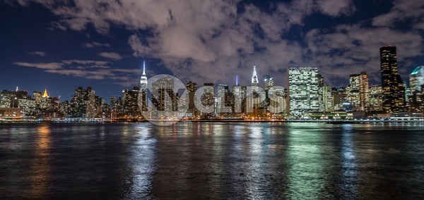 Manhattan skyline in evening with famous skyscrapers and landmarks: Empire State Building, Chrysler, United Nations and East River water