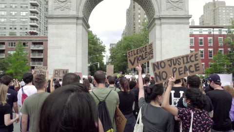 No Justice No Peace and Silence is Violence signs in protest at Washington Square Park under arch New York City