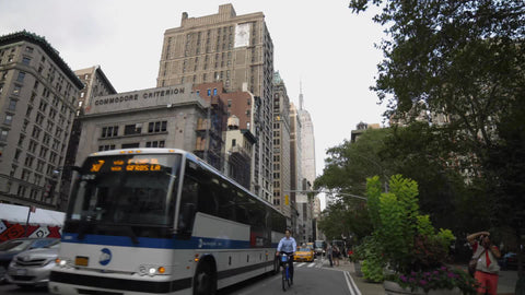 rush hour traffic on lower 5th ave with Empire State Building in background, cloudy spring day in 4K and 1080 HD Manhattan NYC