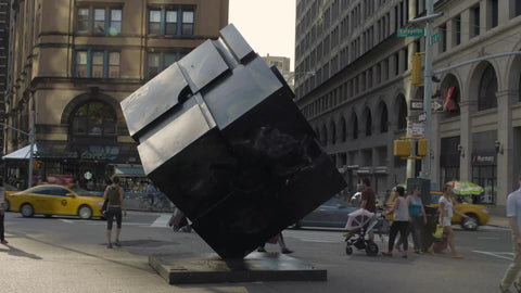 famous cube sculpture in Cooper Square on summer day