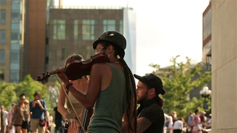 musicians playing violin in Washington Square Park on summer day in NYC